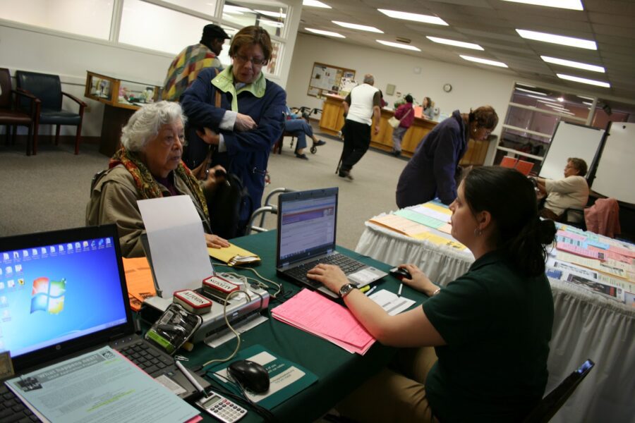 Food Depository SNAP Outreach Coordinator helping South Side resident Catalina apply for SNAP benefits.