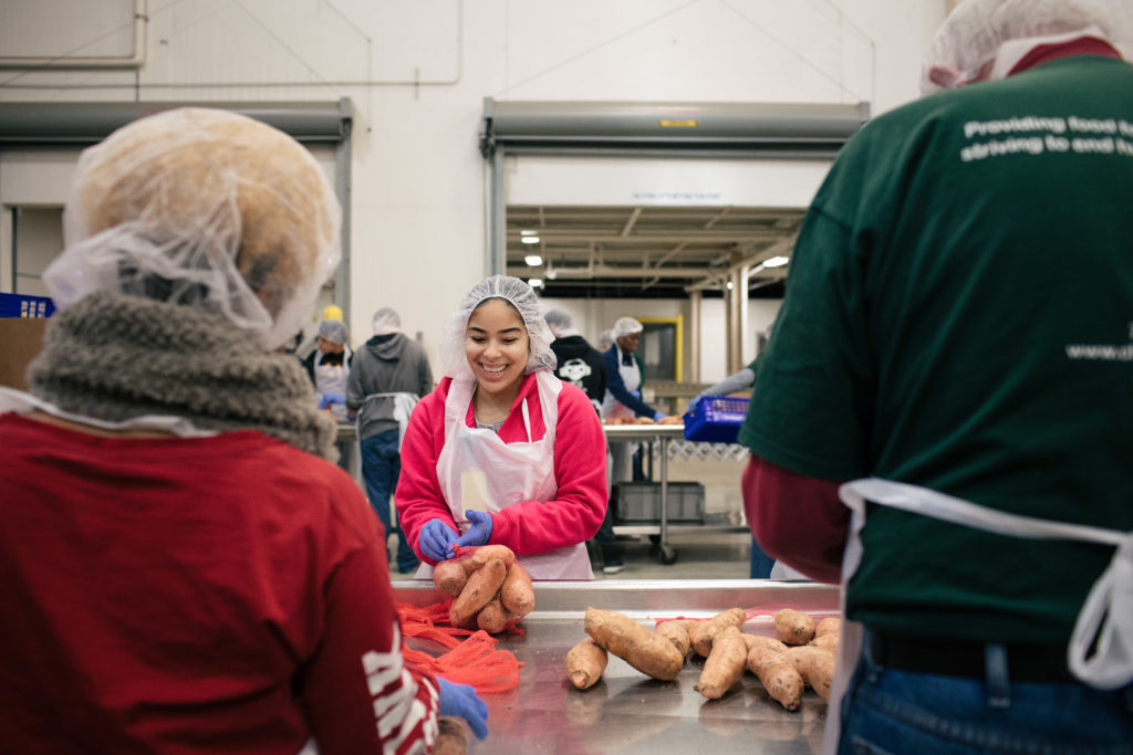 Volunteers pack sweet potatoes at the Greater Chicago Food Depository