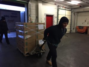 A Food Depository employees unloads food from a truck.