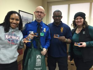 TSA workers hold up their Jewel-Osco gift cards.