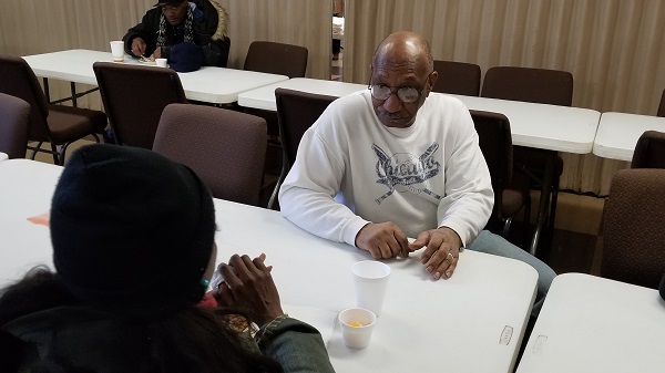 Rev. Ronnie Smith talks to a soup kitchen guest