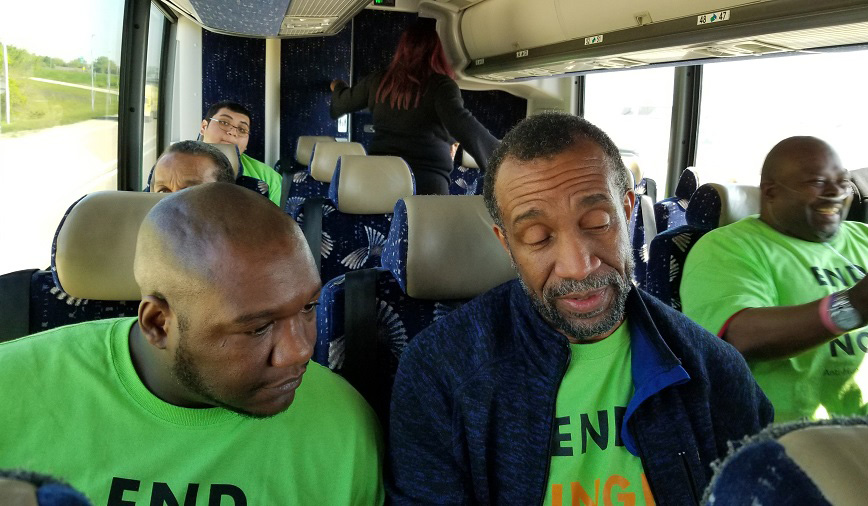 Brian McRae and David Cheeks sit on a bus to Springfield