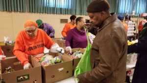 Clifton Young, at right, said the food pantry at St. Ailbe helps him in times of need.