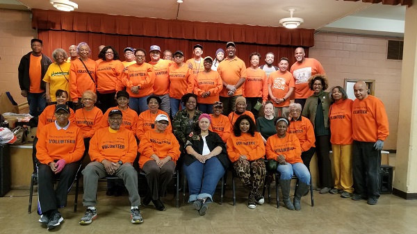 Mabel Wayne, bottom left, and her team of volunteers pose for a group photo at a recent distribution.