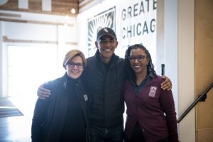 President Barack Obama stand with Food Depository CEO Kate Maehr and Nicole Robinson, Food Depository's vice president of community impact.