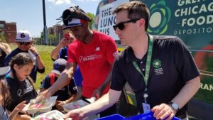 Curtis Granderson and Jim Conwell serve lunch to young ballplayers.