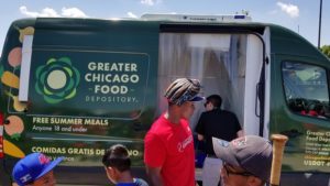 Curtis Granderson helps serve lunch to campers.