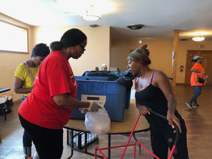 Tiffany Evans, 35, goes through the line at the New Life Covenant Southeast food pantry on a recent summer afternoon. It was her first time at the pantry.