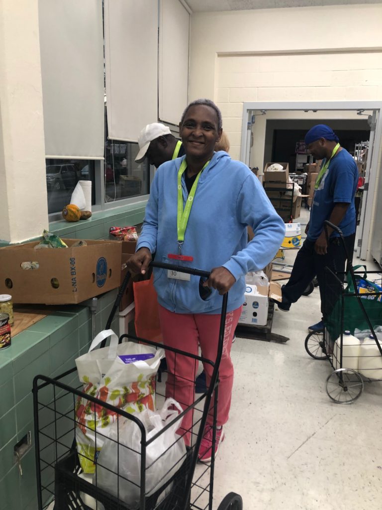 Eleanor Booker of Humboldt Park receives groceries at Mission of Our Lady of the Angels food pantry