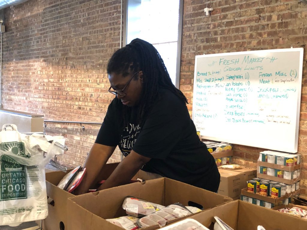 Fresh Market coordinator Wendy Daniels organizes products for a recent distribution. Breakthrough Ministries' food pantry is located in East Garfield Park.