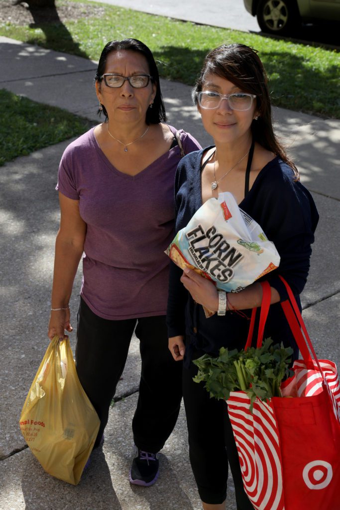 Denise Salinas and her mother, Eleodora, stand outside of the Healthy Student Market at Northwest Middle School in the Belmont-Cragin neighborhood