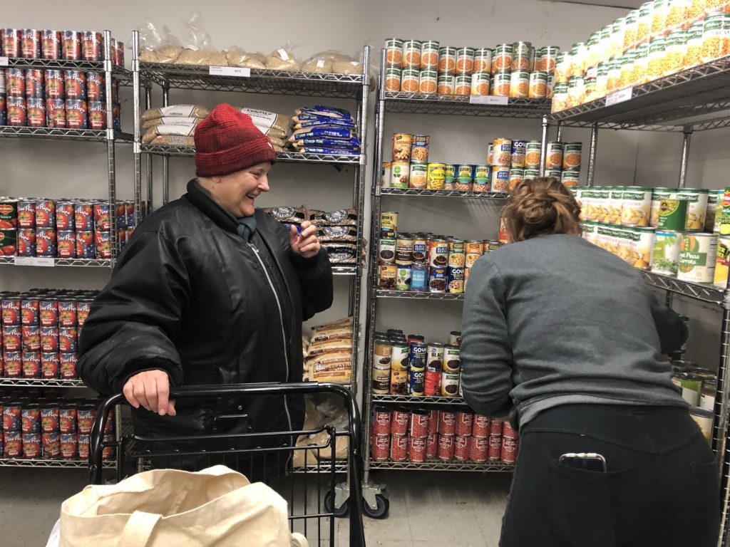 Elizabeth Rhea, 61, picks up groceries in the Maple Morgan Park pantry's upgraded pantry space.