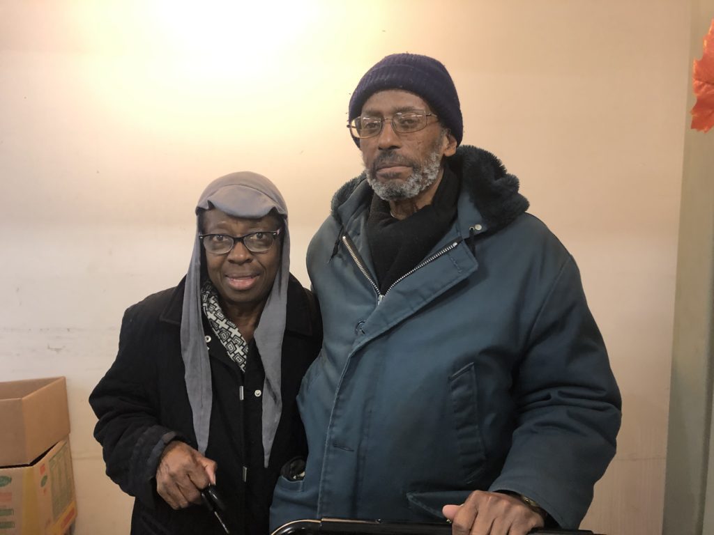 James and Emma Scott pose for a photo before picking up groceries at the Maple Morgan Park pantry