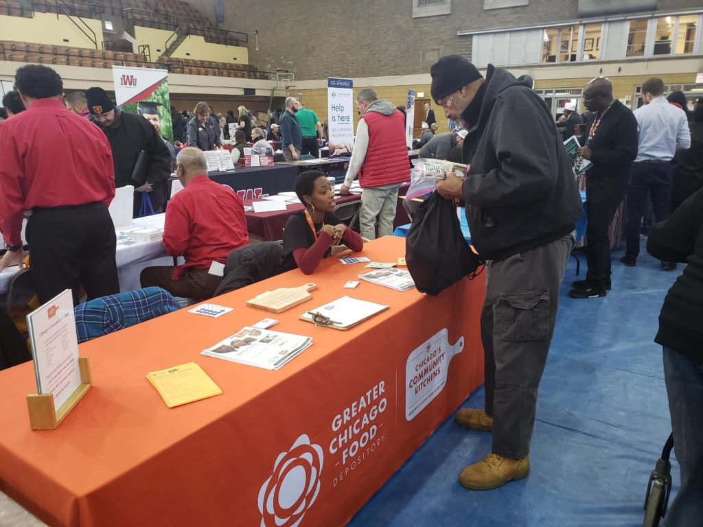 Representatives from Chicago's Community Kitchens, the Food Depository's job training program, speak with veterans attending the Chicago Standdown.