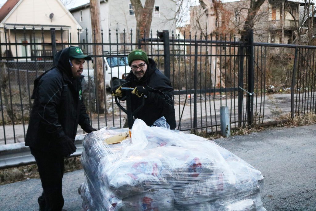 Food Depository staff Oskar Cerda and Steve Castro unload their truck of Thanksgiving food