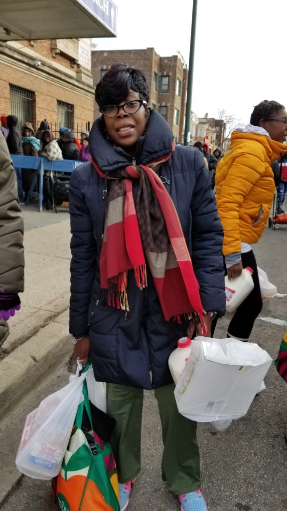 Yvette Osborne, a single mom of twin girls, received a bag of groceries at the Beautiful Zion Missionary Baptist Church holiday distribution the Saturday before Thanksgiving. 