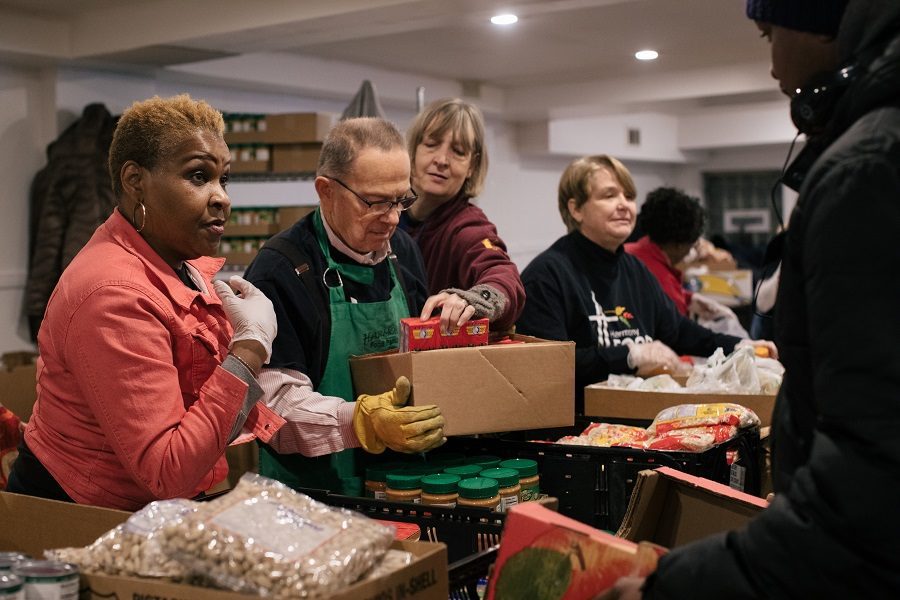 Volunteers at the Harmony Community Church food pantry help clients.
