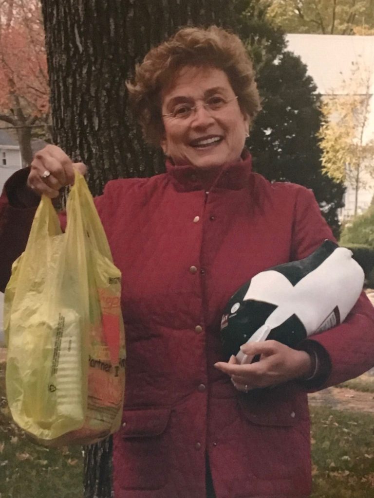 Fran Leib holding a turkey and other food donated to help her neighbors in need.