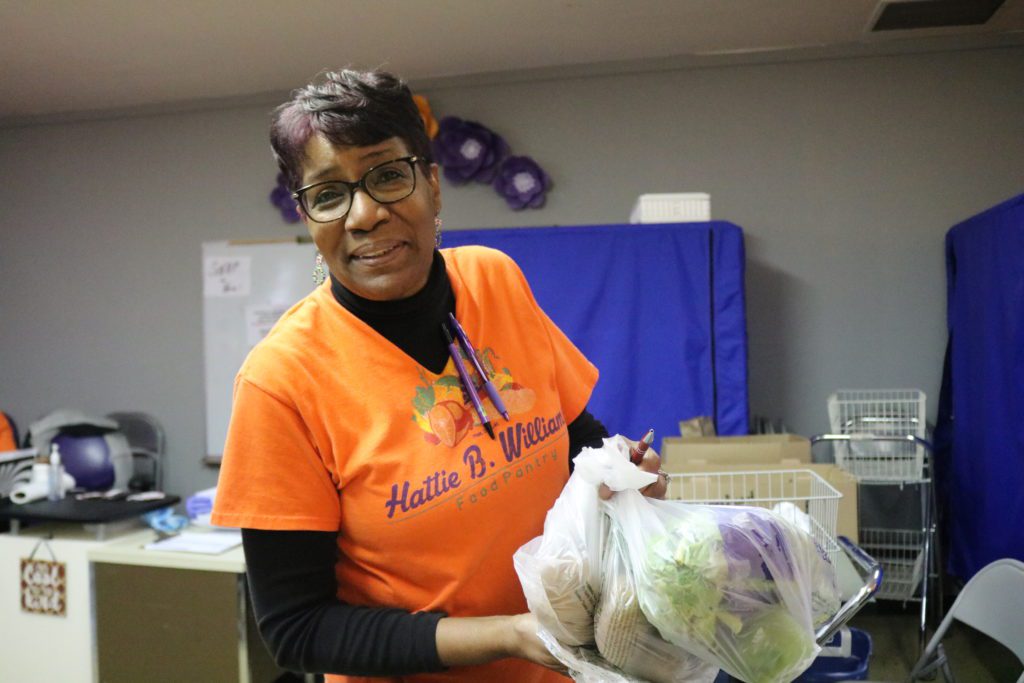 Pantry coordinator Annie Hill poses for a photo during a distribution at the Hattie B. Williams food pantry