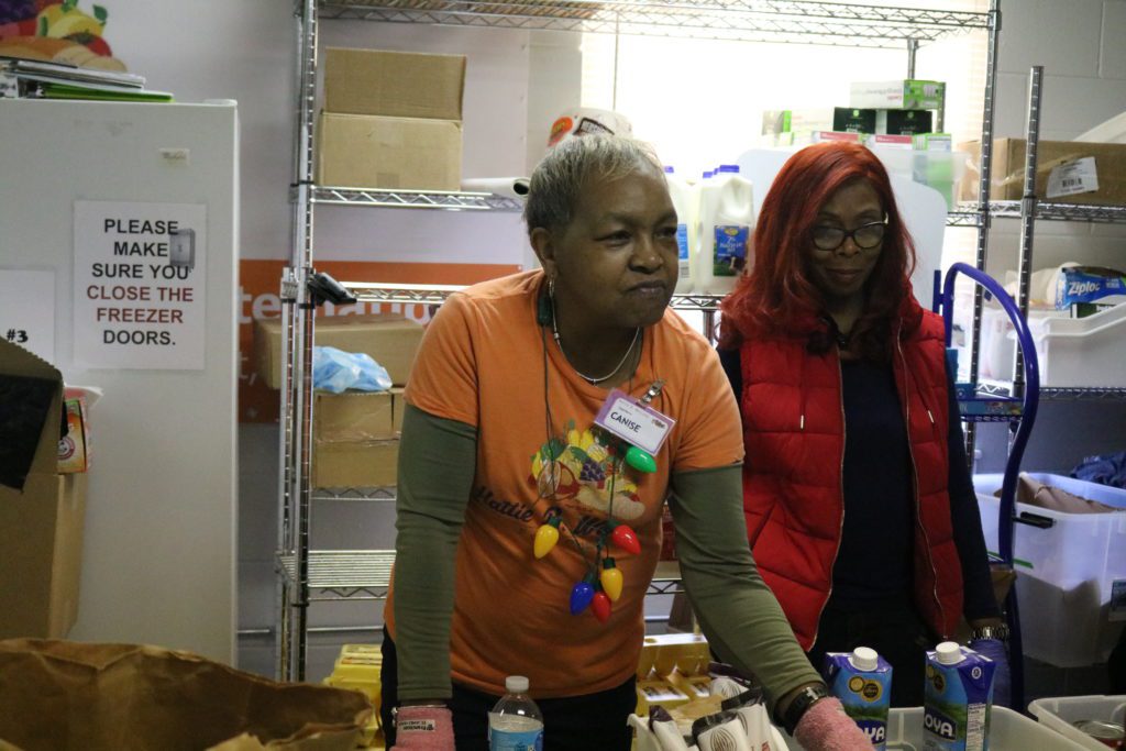 Volunteer Canise Irons distributes food at the Hattie B Williams pantry