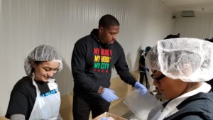 Jahmal Cole, founder of My Block, My Hood, My City repacks food with teens on the MLK Day of Service.