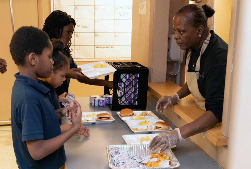 Lavern Short serves supper to the kids at the Future Ties after-school program