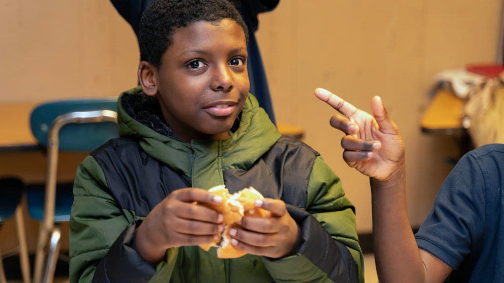 A Future Ties student eats his supper, which is provided as part of an after-school meal partnership with the Greater Chicago Food Depository. 