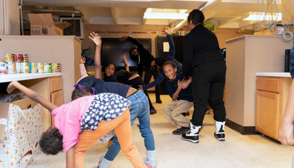 Jennifer Maddox leads the Future Ties kids in a group stretch