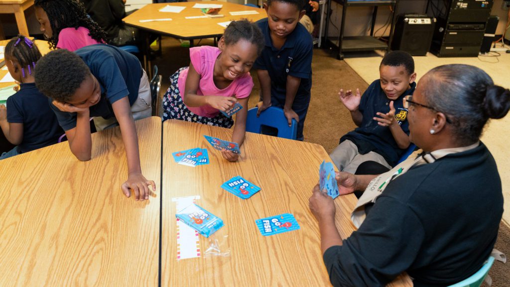 Lavern Short, who served supper to the Future Ties students, joins them for a game of Uno.