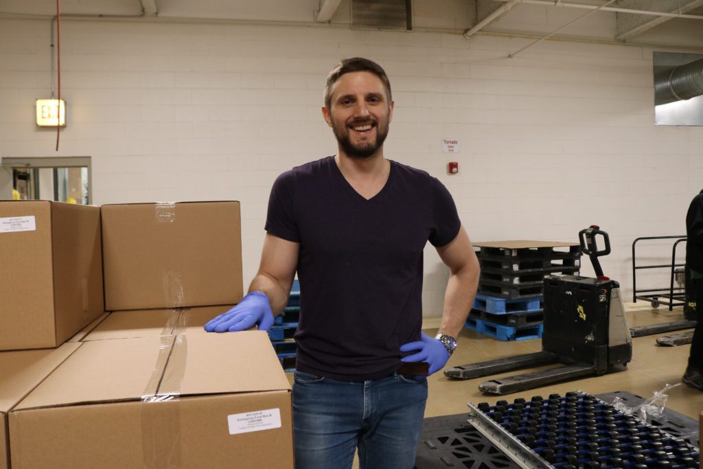 Andrew Weithe, a regular volunteer at the Food Depository, poses for a photo while volunteering in the warehouse