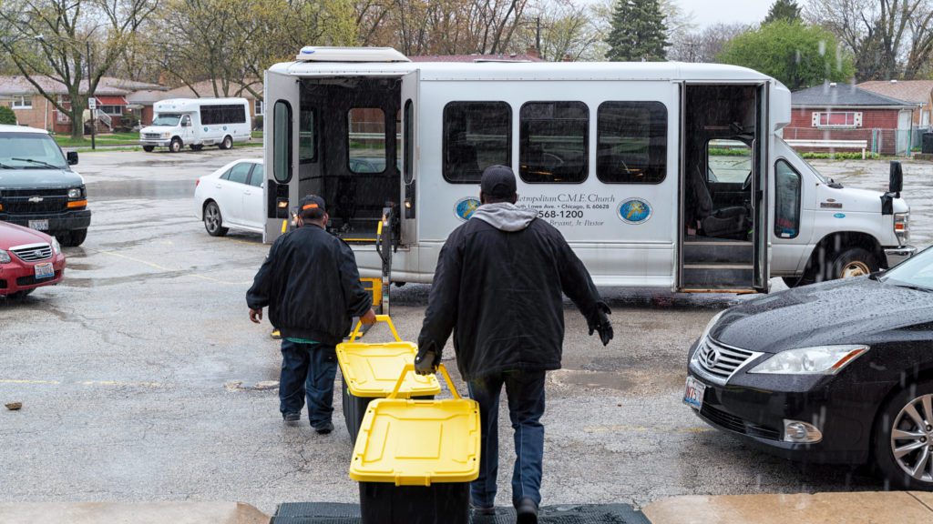 Elbert Clinton, a minister at Allen Metropolitan C.M.E. Church, fills a bus with 150 dinners in to-go containers. Clinton delivered the meals to staff at Roseland Community Hospital. 