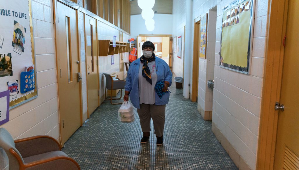 Janet Rogers leaves the Allen Metropolitan C.M.E. Church with meals for her sister