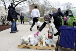 Vera Woods, 79, picks up bags of food