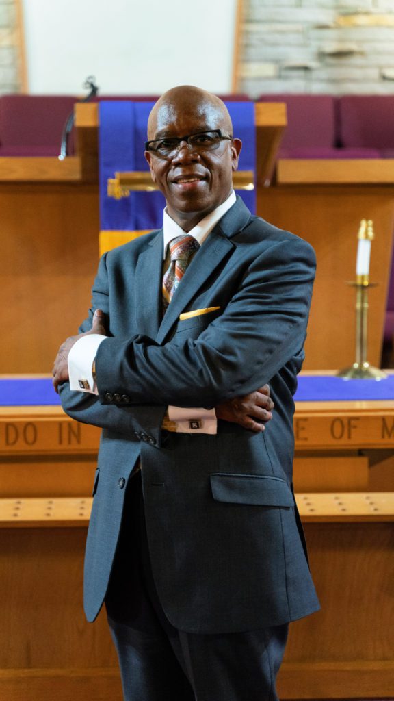 Pastor Bryant poses in the sanctuary at the Allen Metropolitan C.M.E. Church