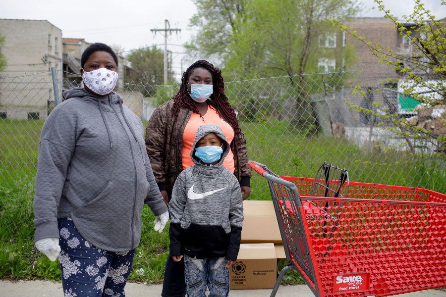 A family waits in line for food at The Quarry Arts and Wellness Center in South Shore