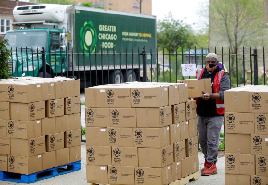 A volunteer at The Quarry Arts and Wellness Center in South Shore picks up one of the Food Depository's family food boxes for distribution