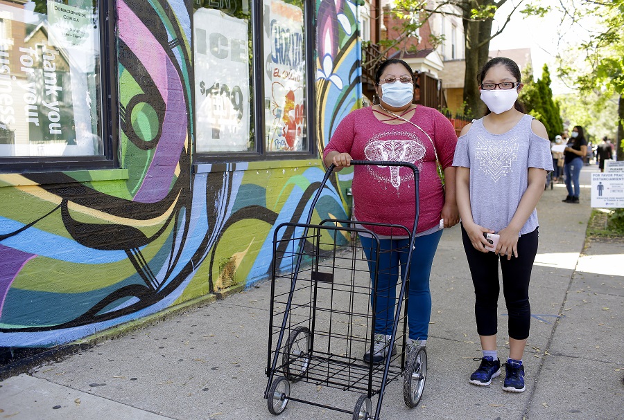 Jasmine, 13 (right) and her mother, Viviana Bahena at the New Life pop-up distribution. 