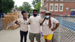 Anton Seals, center, lead steward for Grow Greater Englewood, poses with two of his fellow volunteers.