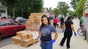 Cecille DeMello, executive director of Teamwork Englewood, volunteers at the pop-up food distribution.