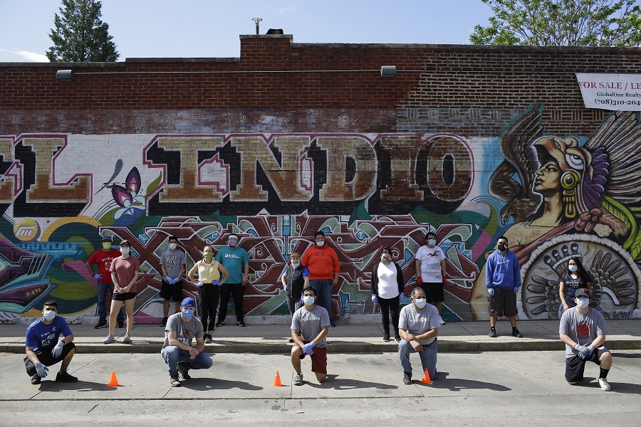 Volunteers with New Life Church help residents effected by the Coronavirus (COVID-19) outbreak as they distribute food donated by the Greater Chicago Food Depository in the Little Village neighborhood on Friday, May 26, 2020 in Chicago, Illinois. 