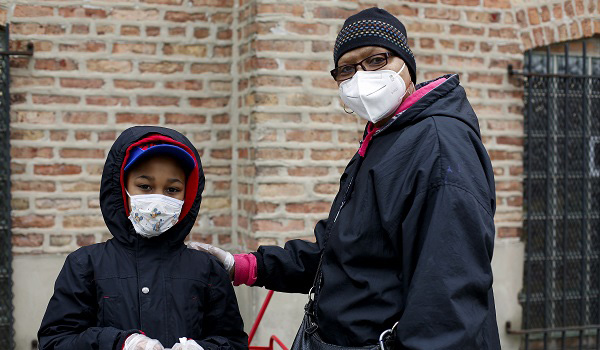 A mother and son wait at a food pantry