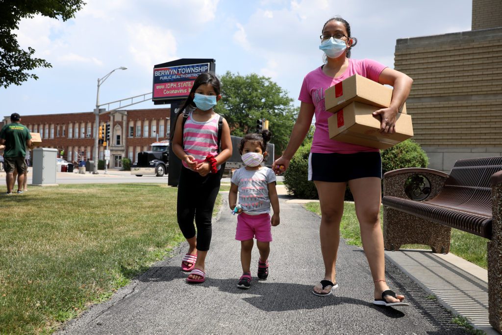 Elizabeth Contreras with her two daughters, 7-year-old Yaretzi and 2-year-old Camila, at the Berwyn Lunch Bus