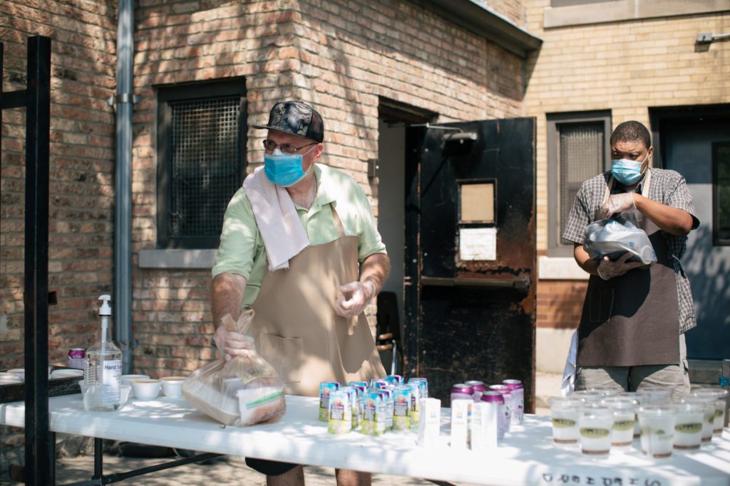 Providence Soup Kitchen volunteers distribute food outdoors.