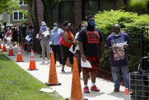 People line up for food at a pop-up distribution at the Apostolic Church of God in Woodlawn.