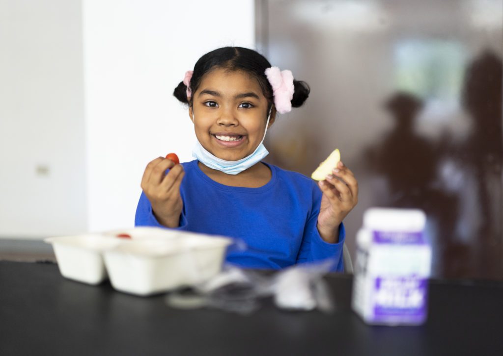 Gabriella Jeffires, 7, eats her lunch at the South Side YMCA