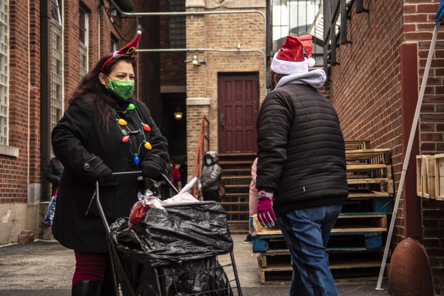 Sylvia Colin receives food at the Our Lady of Fatima church holiday distribution in Brighton Park