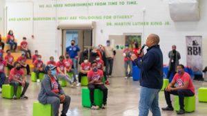 Carlos Nelson, executive director of the Greater Auburn Gresham Development Corporation, addresses the volunteers at the Food Depository's second annual Martin Luther King, Jr. Day of Service