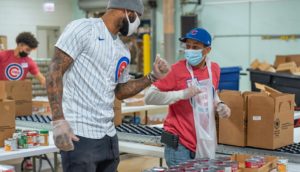 Cubs outfielder Jason Heyward delights a youth baseball coach during the volunteer project.