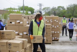 Volunteers provide boxes of emergency food at a pop-up distribution in May at the Trinity United Church of Christ in Washington Heights.