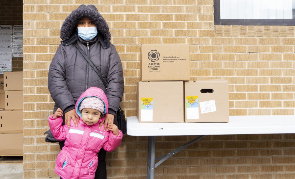 Maria Luisa Diaz and her daughter, Adilene, stop for groceries at the Iglesia Evangelica Emanuel food pantry.